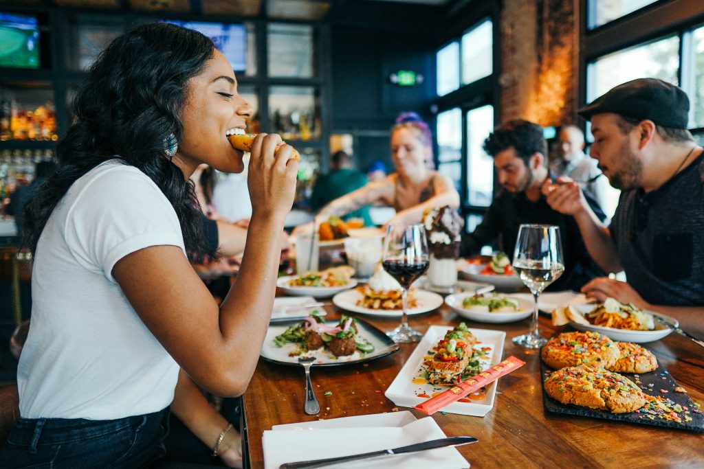 female eating food at a restaurant.